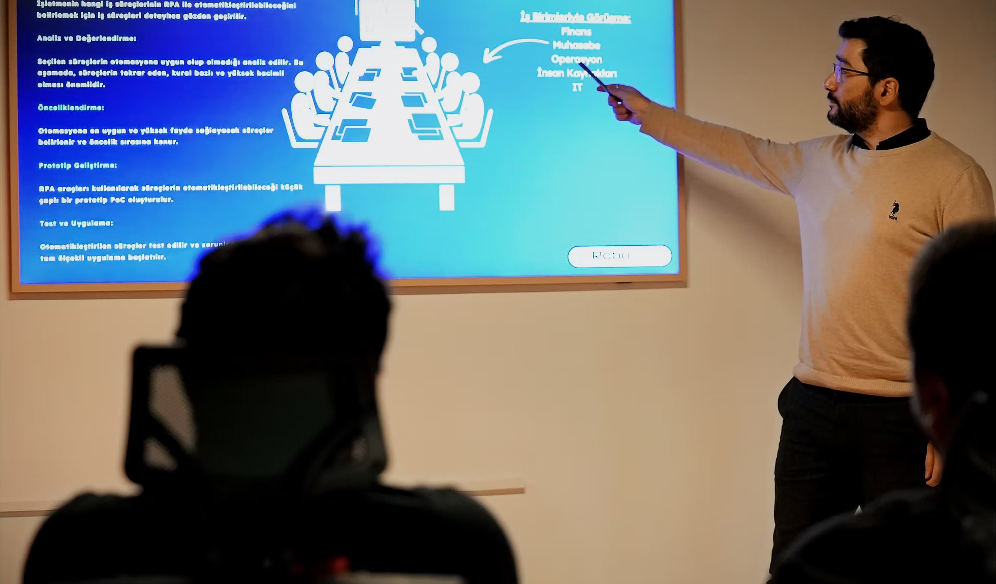 A RoboNest trainer walks participants through the RPA process selection and prioritisation method on screen.